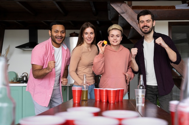 People playing beer pong at an indoor party