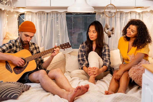 People playing guitar in the van  adventure road trip concept