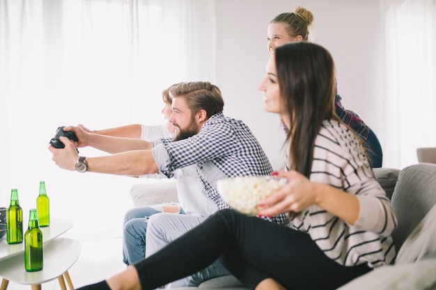 People playing videogamen in group of friends