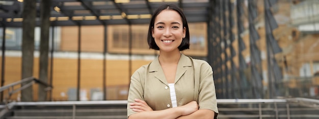 People portrait of confident korean girl young student cross arms on chest standing in power pose