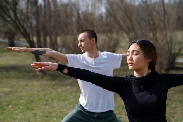 People practicing yoga outside