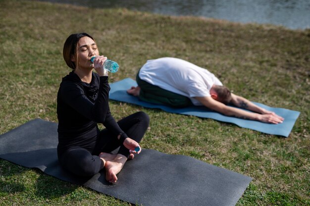 People practicing yoga outside