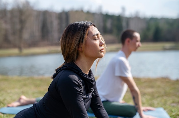 People practicing yoga outside