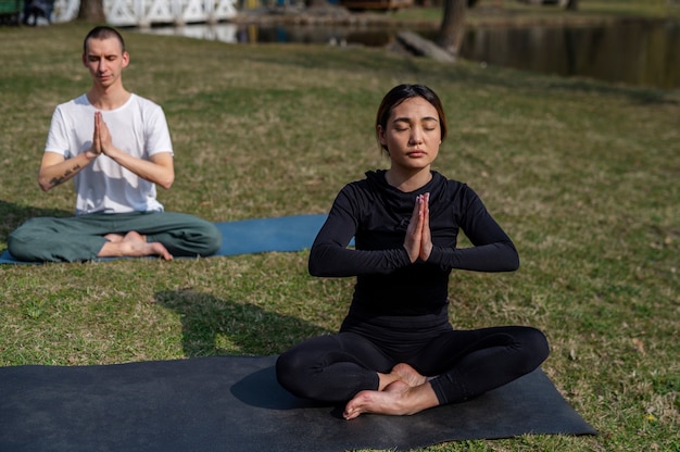 People practicing yoga outside