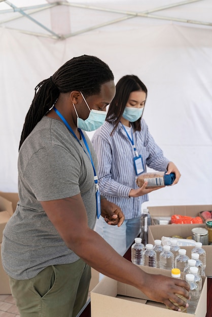 People preparing a charity foodbank for poor people