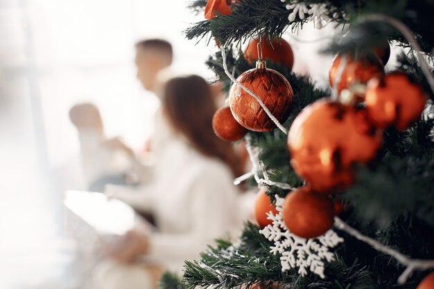 People preparing for Christmas. People sitting on a bed. Family is resting in a festive room.