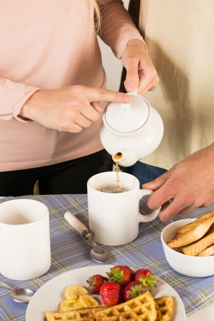 People preparing delicious breakfast