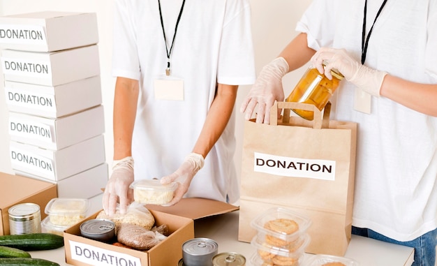 Free photo people preparing food box and bag for donation