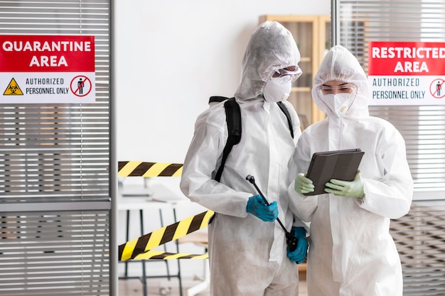 People in protective equipment disinfecting a dangerous area