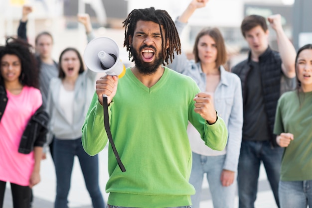 Foto gratuita le persone che protestano nelle strade vista frontale