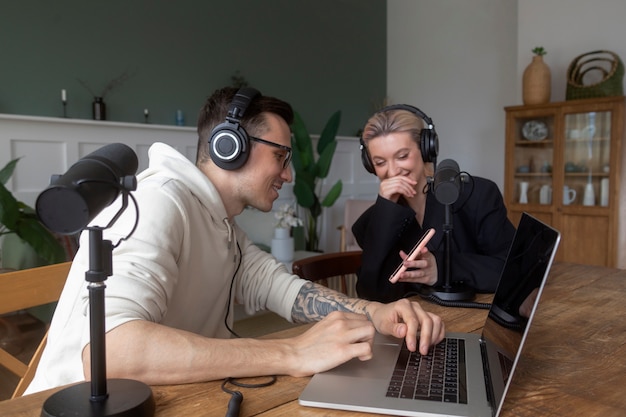 People recording podcast indoors medium shot