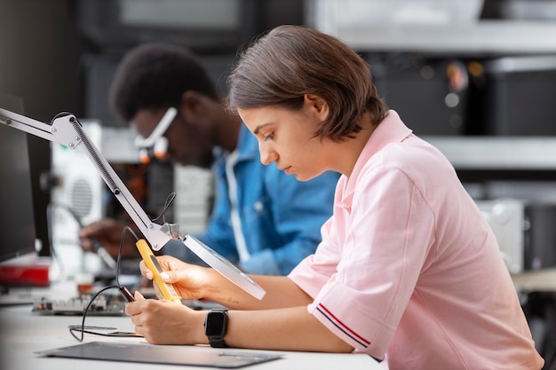 people repairing computer chips