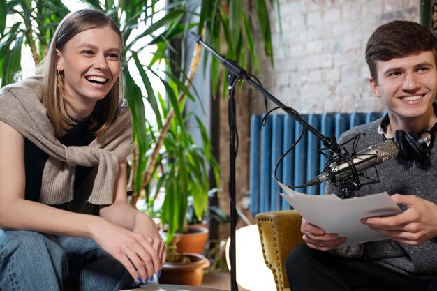 People running a podcast with microphones and headphones from the studio