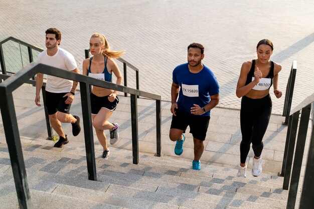 People running on stairs full shot