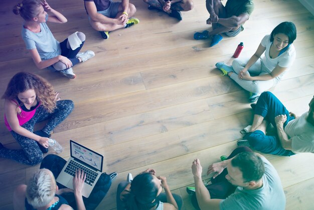 People seated in a circle in yoga class