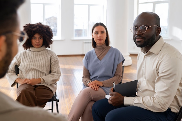 Free photo people sharing feelings and emotions during group therapy session