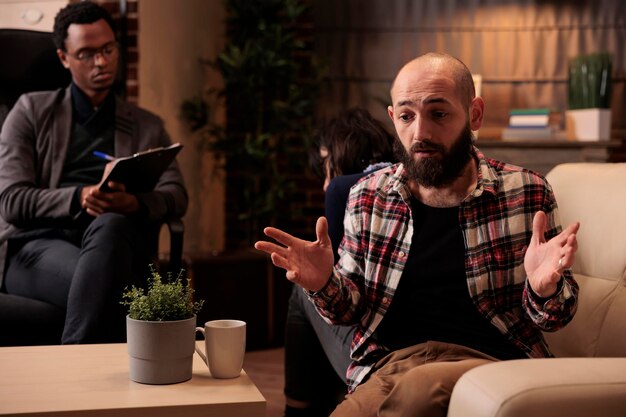 People sitting back to back arguing at couple therapy session with counselor, trying to solve relationship problems and conflict. Giving professional advice to save marriage.