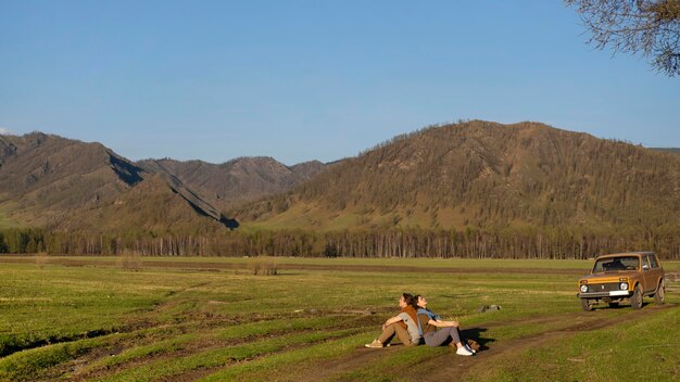 People sitting on grass long shot