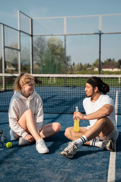 People sitting outdoors with drinks full shot