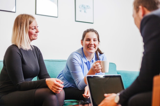 People sitting in relaxation room smiling