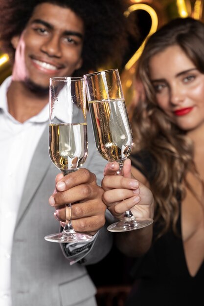 People smiling and holding glasses of champagne close-up