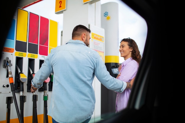 Free photo people spending time at the gas station