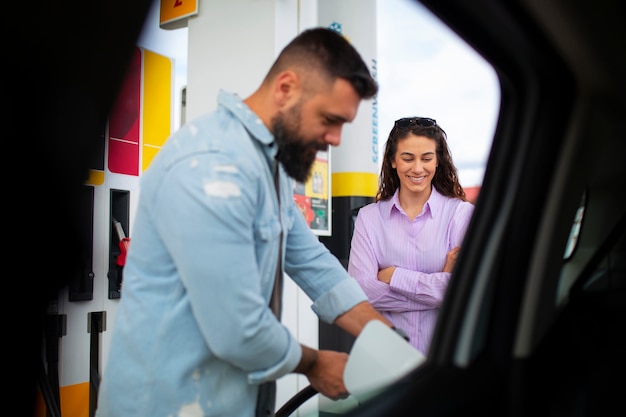 Free photo people spending time at the gas station