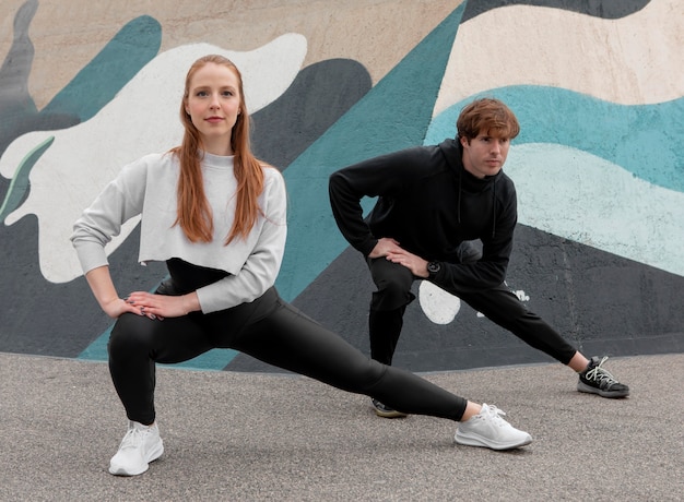 People in sportswear exercising outdoors