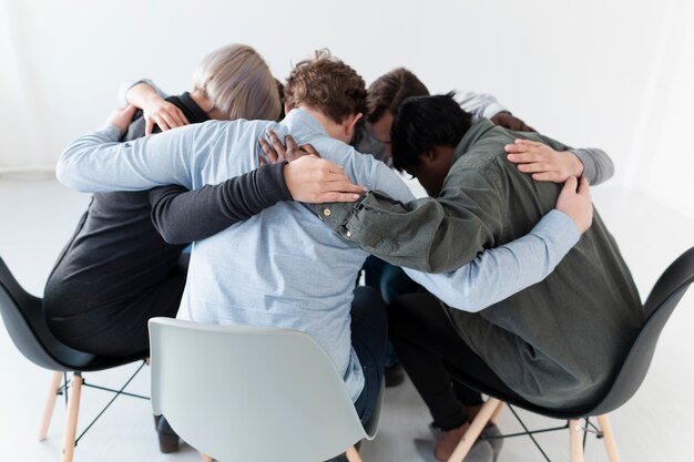 People standing on chairs and embracing