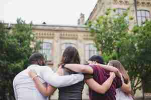 Free photo people standing together hugging