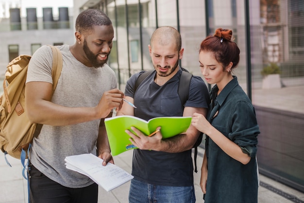 People standing with papers outdoors