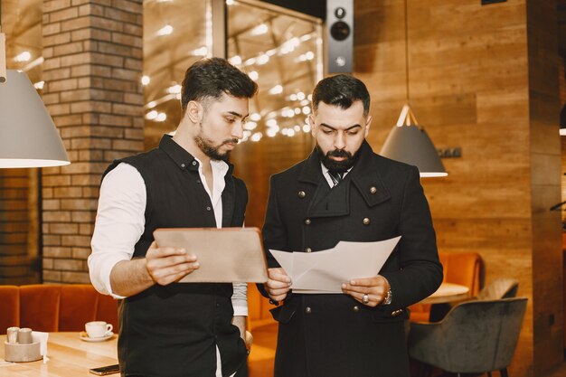 People stands and looks in a documents