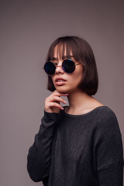 People, style and fashion concept - happy young woman or teen girl in casual clothes and sunglasses