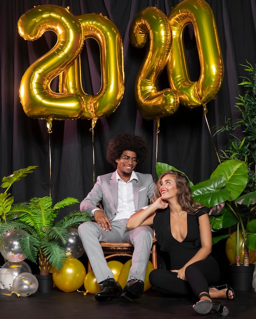 People surrounded by balloons and plants