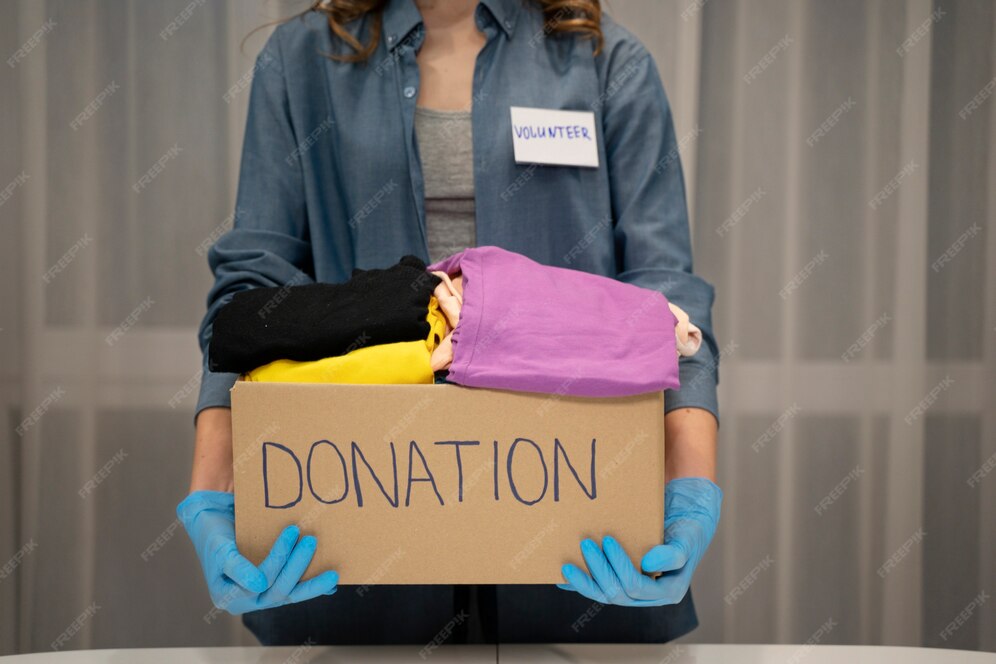 Woman holding a box of donated clothes 