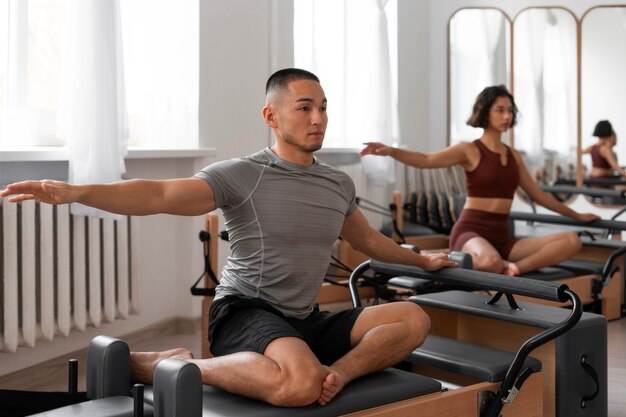 People taking  pilates reformer class