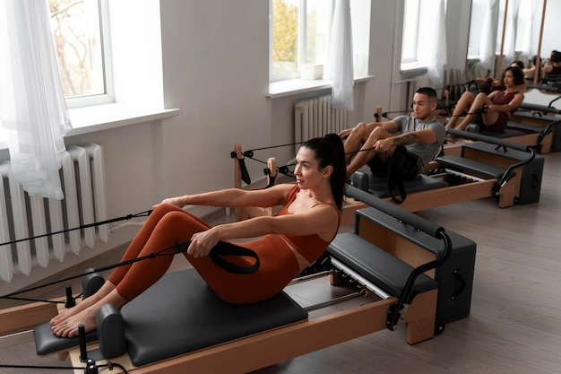 people taking  pilates reformer class