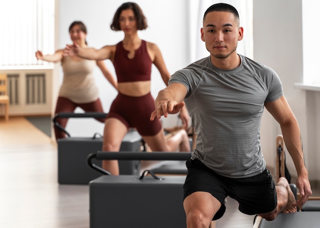 People taking  pilates reformer class