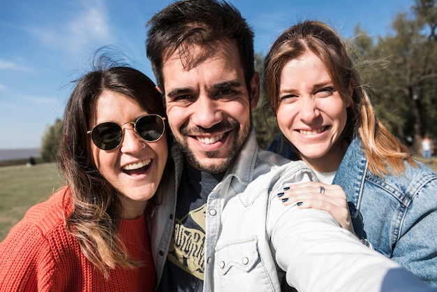 People taking selfie on trees background