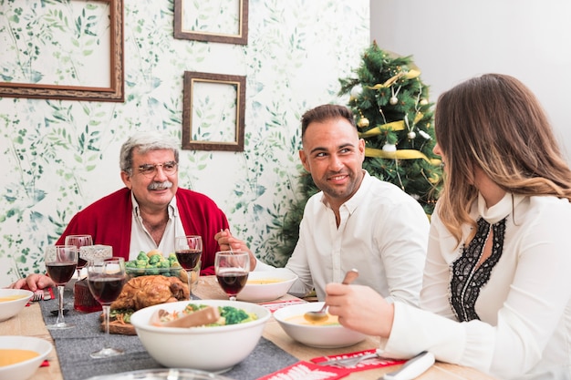 People talking at festive table 
