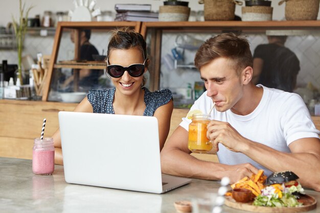 People, technology and leisure concept. Cute couple having fun