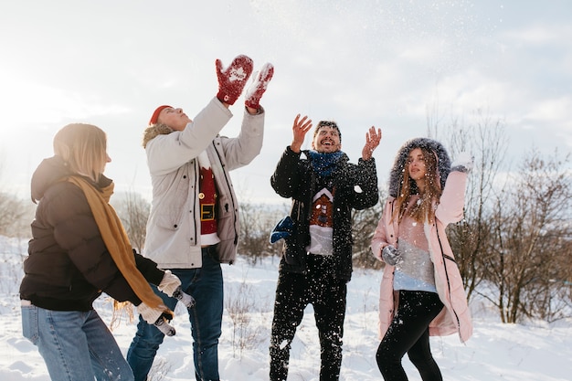 People throwing snow in air 