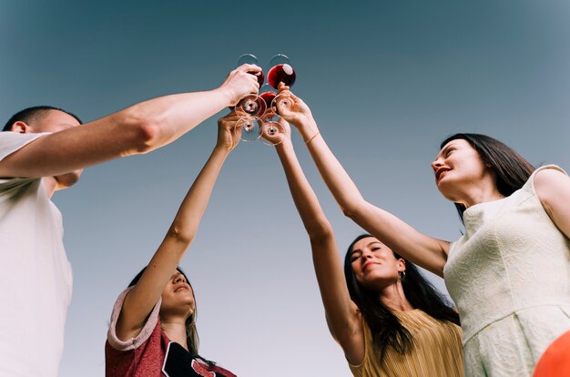 People toasting wine from below