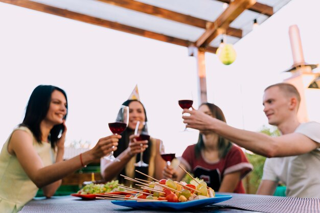 People toasting wine at party