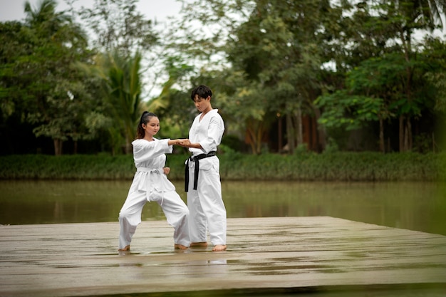 People training together outdoors for taekwondo