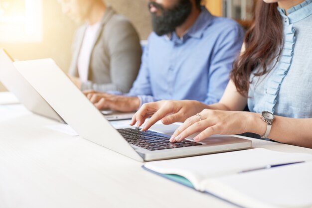 People typing on computers