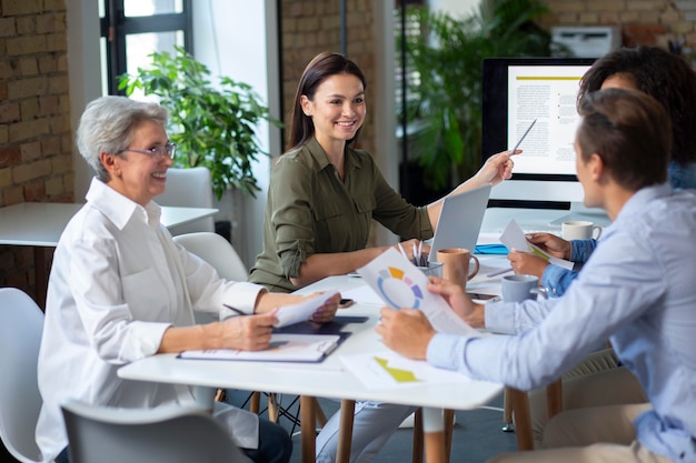 People using digital device while in a meeting