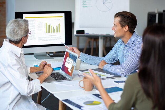 People using digital device while in a meeting