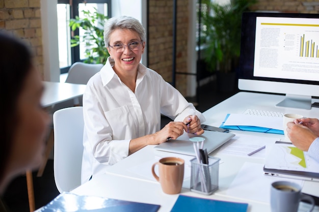 People using digital device while in a meeting