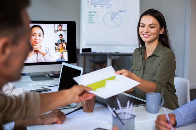 People using digital device while in a meeting